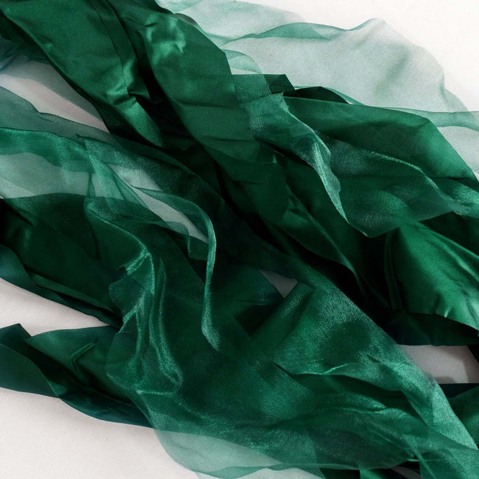 Green sheer fabric ribbons draped elegantly on a white background. #whtbkgd