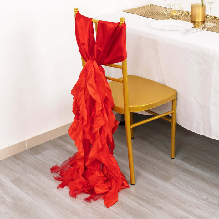 Red ruffled chair cover draping elegantly on a gold chair at a dining table.