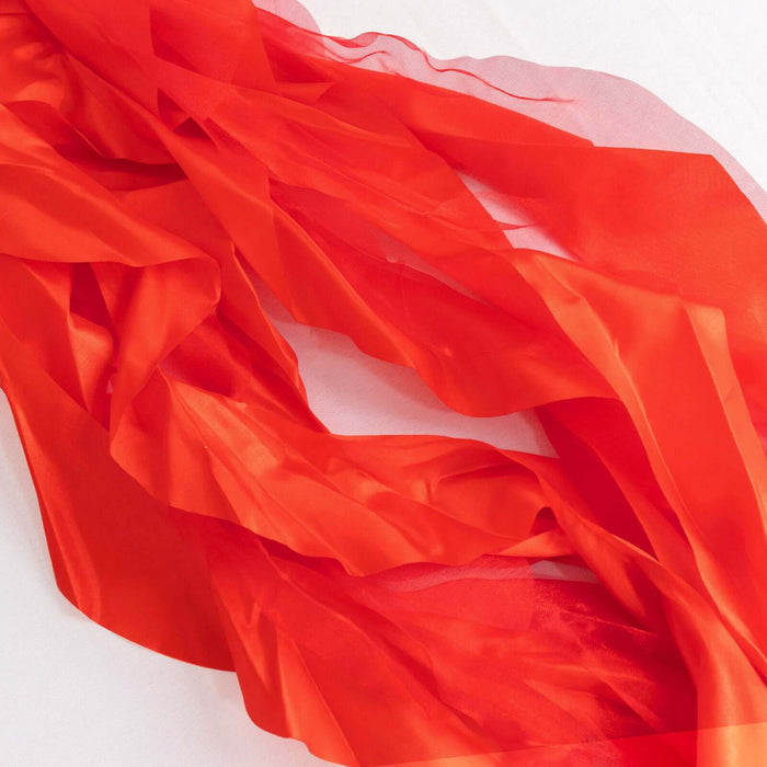 Sheer red fabric draped elegantly on a plain background. #whtbkgd