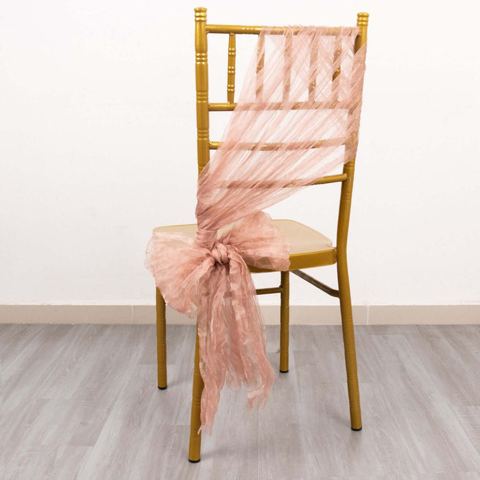 Peach tulle chair sash draped on a gold chiavari chair