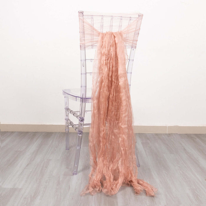 Peach chiffon drape elegantly styled on a clear acrylic chair.