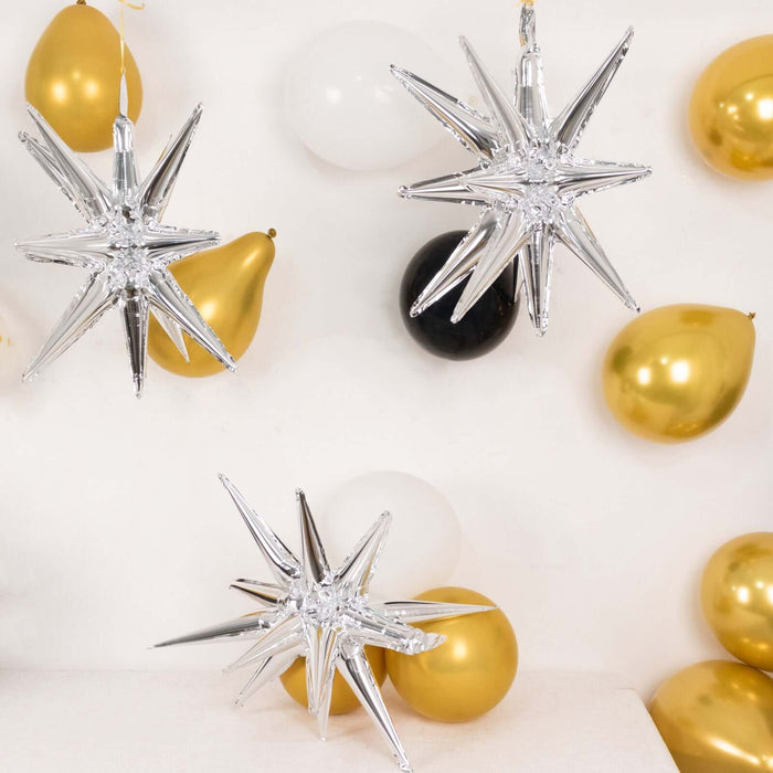 Silver star-shaped decorations with gold and black balloons.