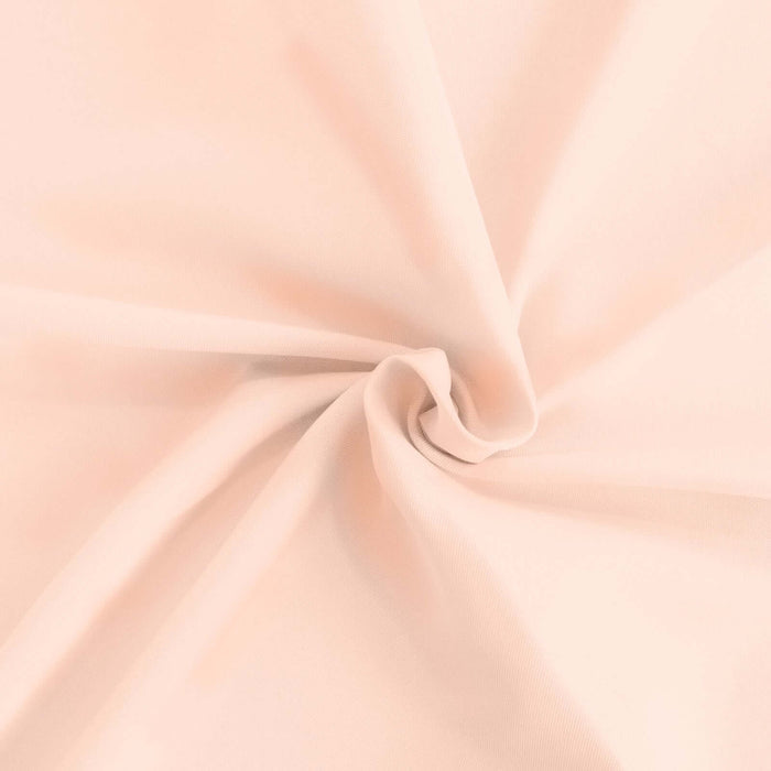 Soft peach fabric with a smooth texture and draping appearance. #whtbkgd