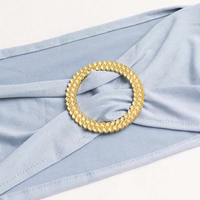 Gold rhinestone embellishment on soft blue fabric. #whtbkgd
