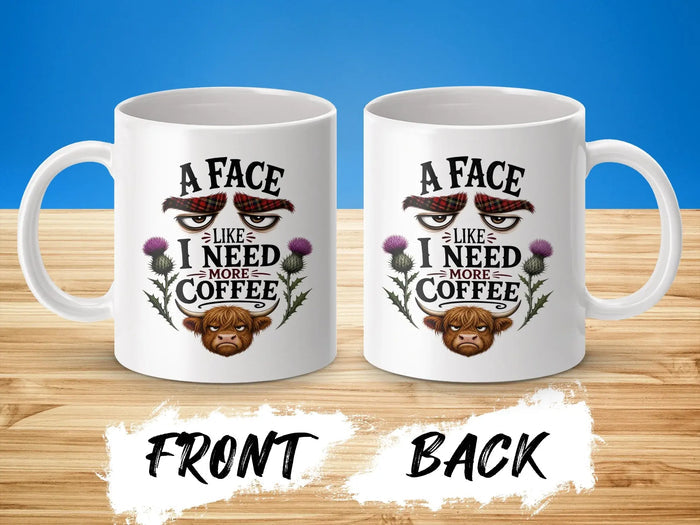White mug with "A face like I need more coffee" text and Highland cow graphic.