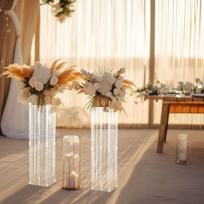Elegant floral arrangements in modern glass vases for a chic event setting.