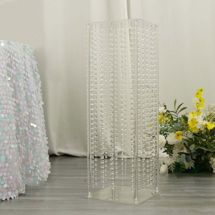 Acrylic display stand with hanging beads for events and decor.