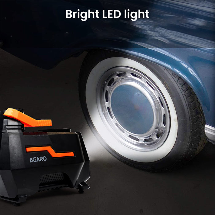 AGARO tyre inflator with bright LED light illuminating a car wheel at night
