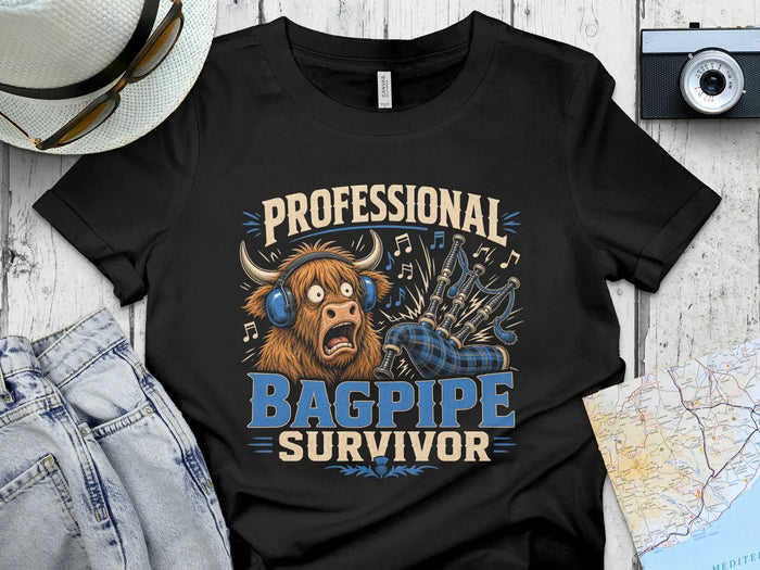 Black t-shirt with "PROFESSIONAL BAGPIPE SURVIVOR" text and a Highland cow illustration.