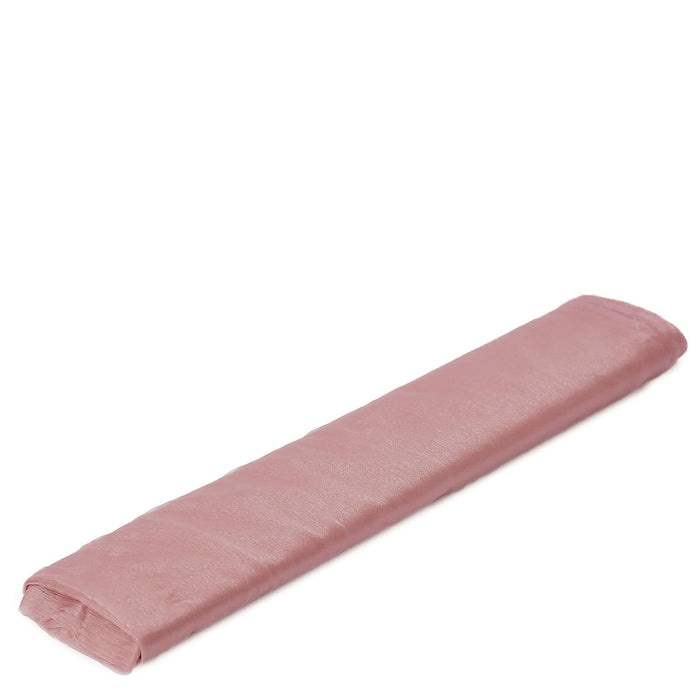 Rolled pink fabric on a plain background