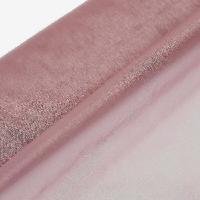 Pink satin fabric draped elegantly on a white backdrop.