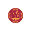 Decorative plate with gold warrior and floral design on a red background
