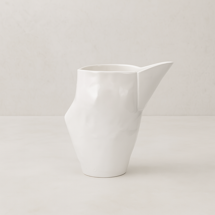 Handmade creamy white ceramic pitcher by Montes Doggett, 9.5"L x 6.5"W x 10"H.