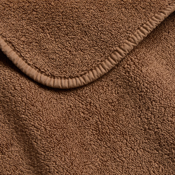 Coffee brown Signature bath sheet with a soft, plush terry texture and a reinforced stitched hem edge.