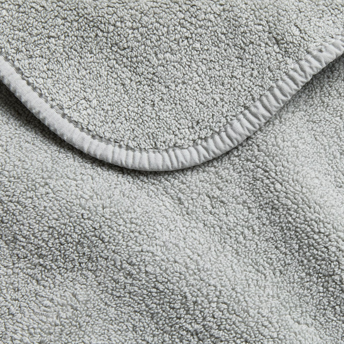 Mist blue Signature bath towel featuring a soft, plush cotton terry texture and a finished stitched edge.