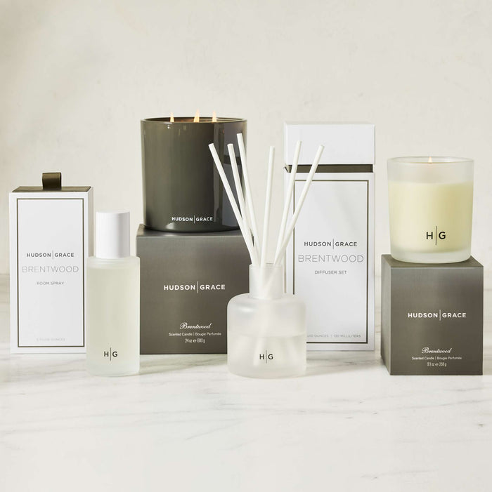 Hudson Grace Brentwood room spray, candle, and diffuser set in white and dark gray packaging.