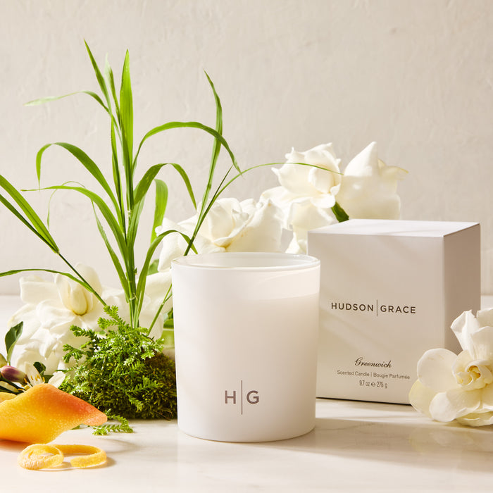 Hudson Grace Greenwich Scented Votive in a white frosted glass vessel with "HG" logo, box, and gardenias.