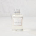 Hudson Grace Montauk scented reed diffuser oil refill, clear glass bottle with silver cap and white label.