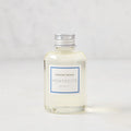 Hudson Grace Montecito 4oz clear glass diffuser oil refill bottle with silver cap and blue label.