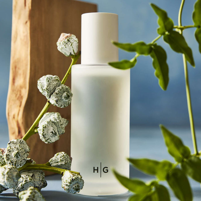 Hudson Grace Montecito diffuser oil refill, frosted white bottle with "HG" logo, eucalyptus branch, wood.