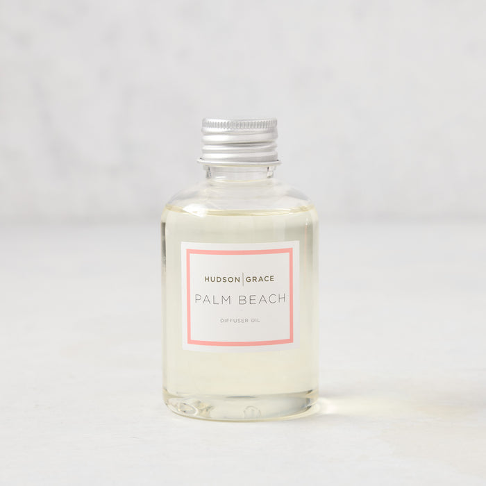 Hudson Grace Palm Beach scented diffuser oil in a clear glass bottle with a silver cap and pink label.