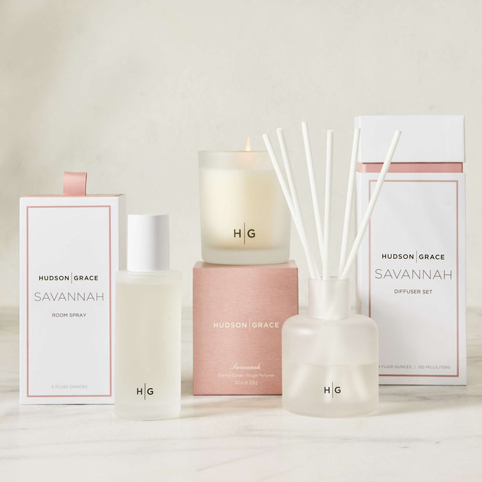 Hudson Grace Savannah scented collection: room spray, candle, and reed diffuser, all in white and blush packaging.