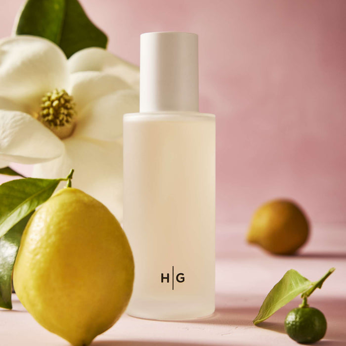 Hudson Grace Savannah Scented Reed Diffuser Oil Refill, 4oz frosted glass bottle with HG logo, lemon, and magnolia.