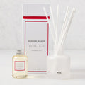 Hudson Grace Winter Scented Reed Diffuser set: frosted white glass vessel, 6 white reeds, and oil bottle.