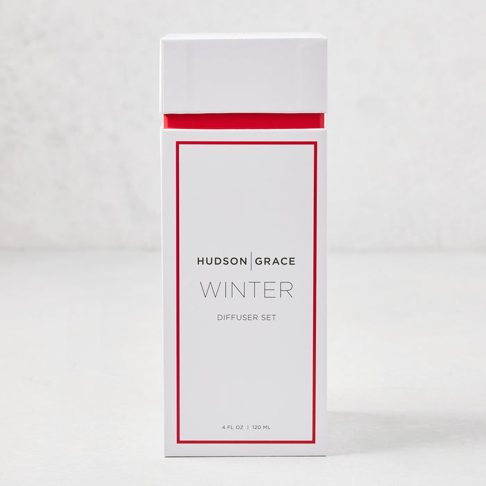 Hudson Grace Winter Scented Reed Diffuser set in a white box with red trim, 4 fl oz.