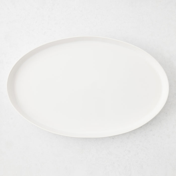 Large white oval stoneware serving platter with a minimalist design, handmade in Portugal.