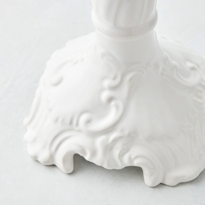 Large white ceramic Tosca candlestick base with ornate Italian-inspired embossed scrollwork detailing.