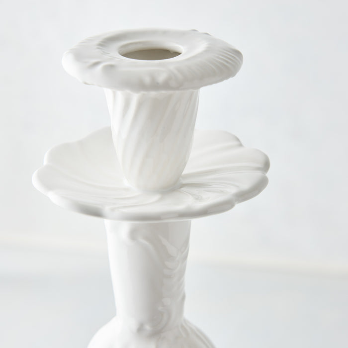 Large white Italian ceramic candlestick with a glossy glaze, ornate fluted base, and scalloped candle cup design.