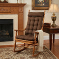 Wooden rocking chair with brown cushions in a cozy living room setting.