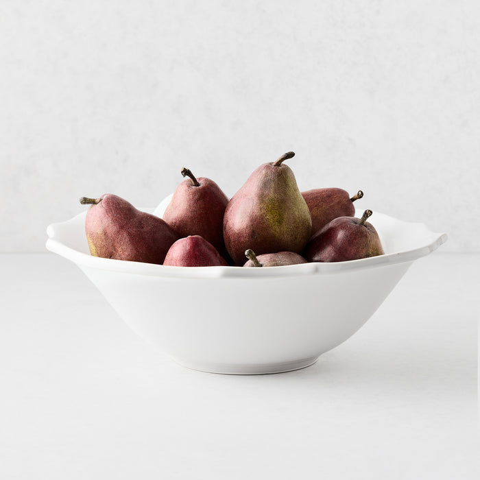 Large white ceramic Lungarno serve bowl filled with red pears, featuring soft edges and a glossy glaze finish.