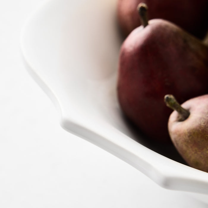 Large white ceramic Lungarno serve bowl with soft edges holding red pears.