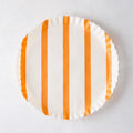 Round white parchment liner with vertical orange stripes and ruffled edges.