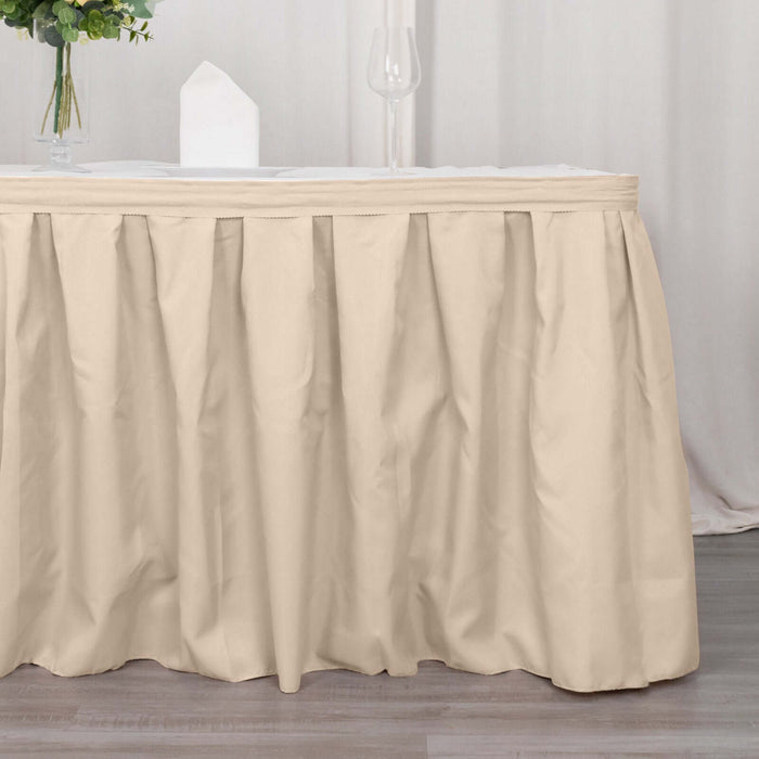 Beige table skirt draped elegantly over a table in a styled setting.