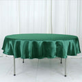 Green satin round tablecloth on a table