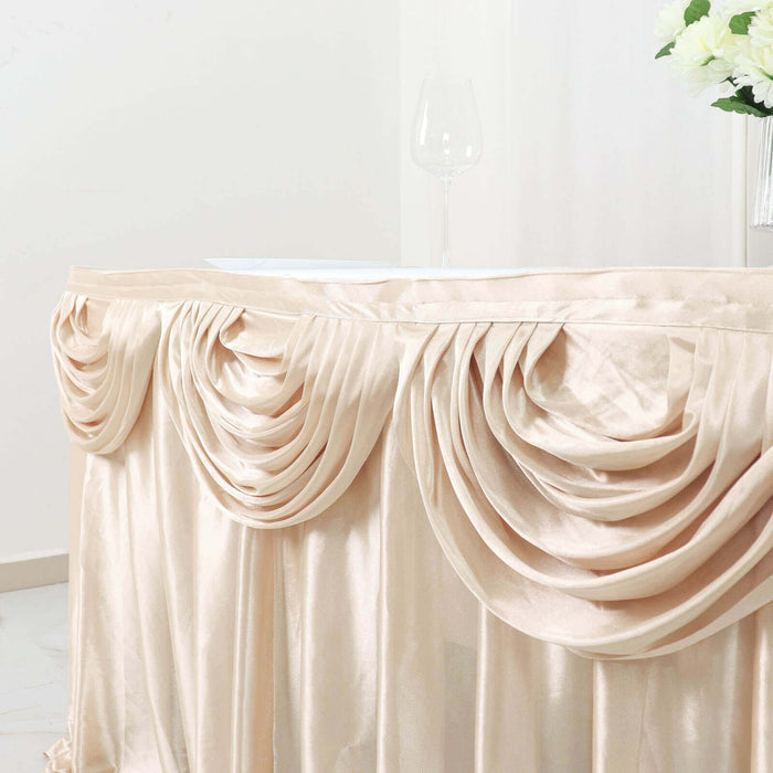Elegant champagne-colored table skirt with pleated draping.
