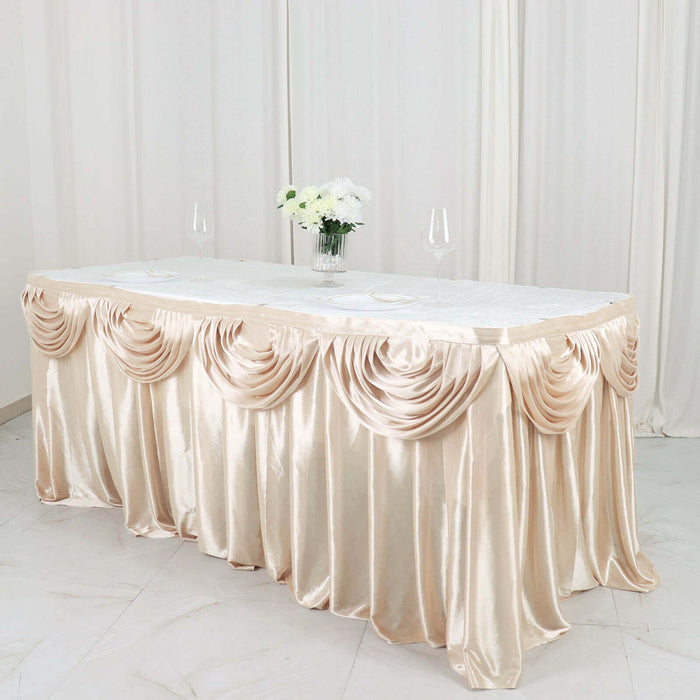 Elegant champagne satin table skirt with draped design for events and parties.