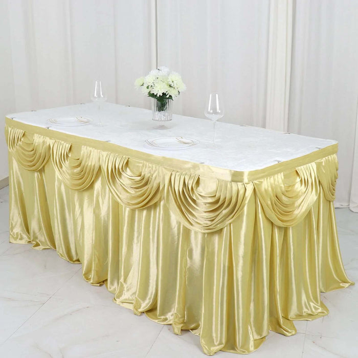 Elegant gold table skirt draped over a banquet table with floral centerpiece.