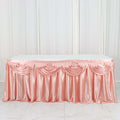 Pink satin table skirt with elegant draping.