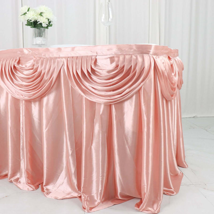 Elegant pink satin table skirt with draped pleats for events and celebrations.