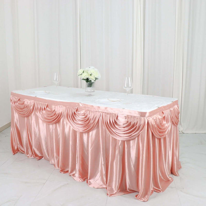 Elegant pink table skirt with draped design for events and celebrations.