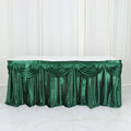 Green satin table skirt with elegant draping for events and celebrations.
