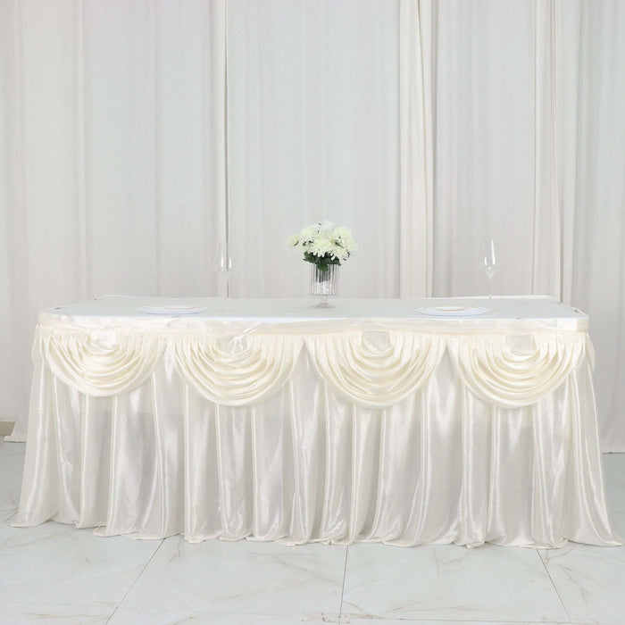 Elegant ivory table skirt with pleated design, perfect for events or weddings.
