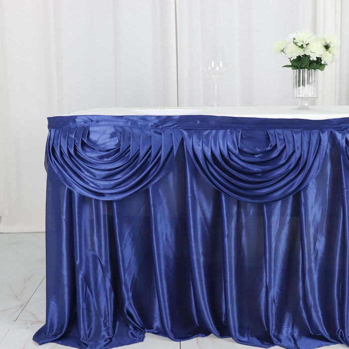 Navy blue table skirt with elegant pleats and draping.