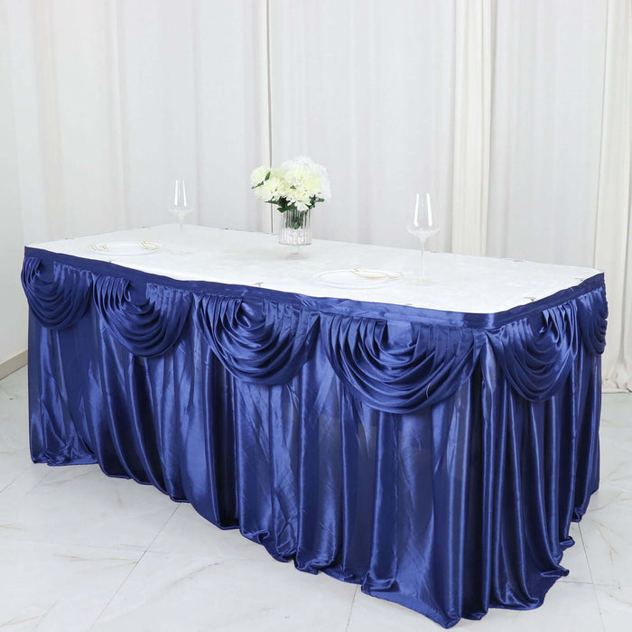 Elegant navy blue table skirt draped with ruffles for events and occasions.