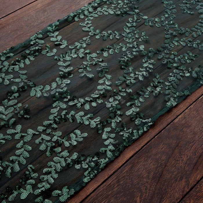 Green embroidered lace fabric with intricate leaf patterns.