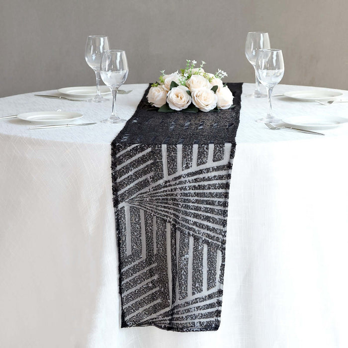 Black and white geometric table runner on a dining table with floral centerpiece.